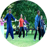 Image of some people doing tai chi in the park.